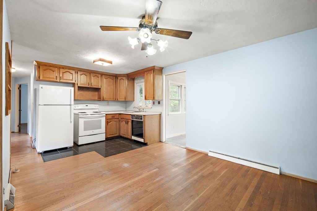 53 Cochato Park Randolph, MA 02368 - Photo 9 of 20 a kitchen with a refrigerator a sink dishwasher and a stove with wooden floor