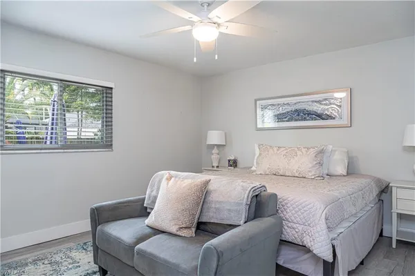 a room with a bed couch and window