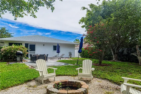 a view of a house with backyard sitting area and garden