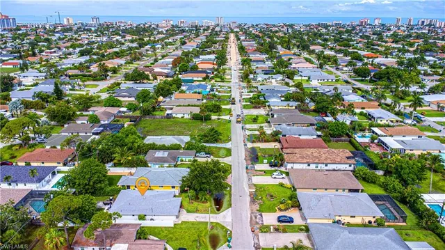 an aerial view of residential houses with outdoor space and street view