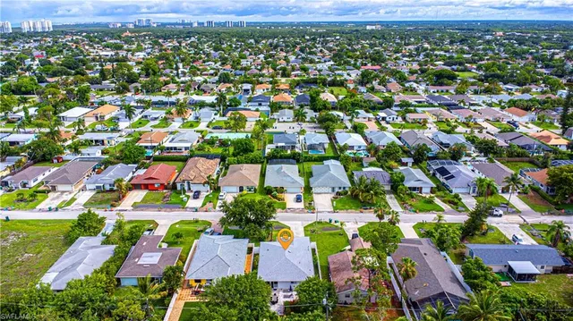 an aerial view of residential houses with outdoor space and trees