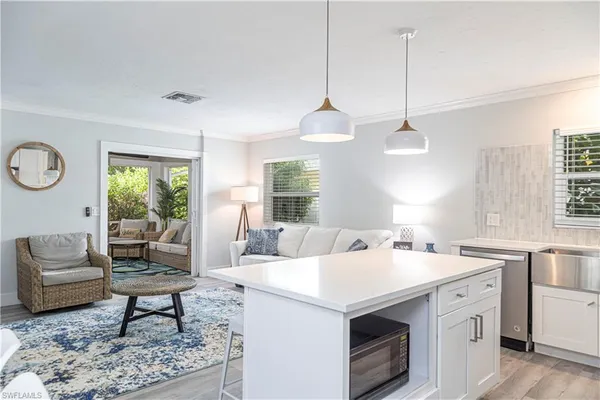 a living room with furniture a rug a lamp and a window
