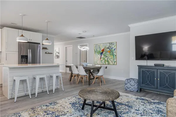 a view of a livingroom with furniture and a flat screen tv