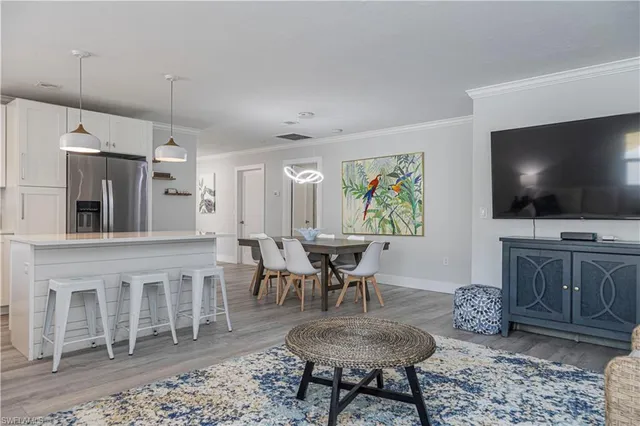a view of a livingroom with furniture and a flat screen tv
