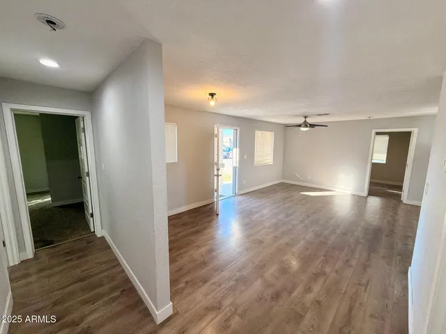 a view of a hallway with wooden floor