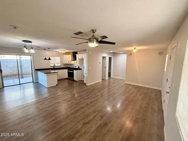 a view of a kitchen with a sink and a refrigerator