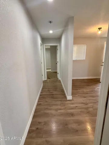 a view of a hallway with wooden floor