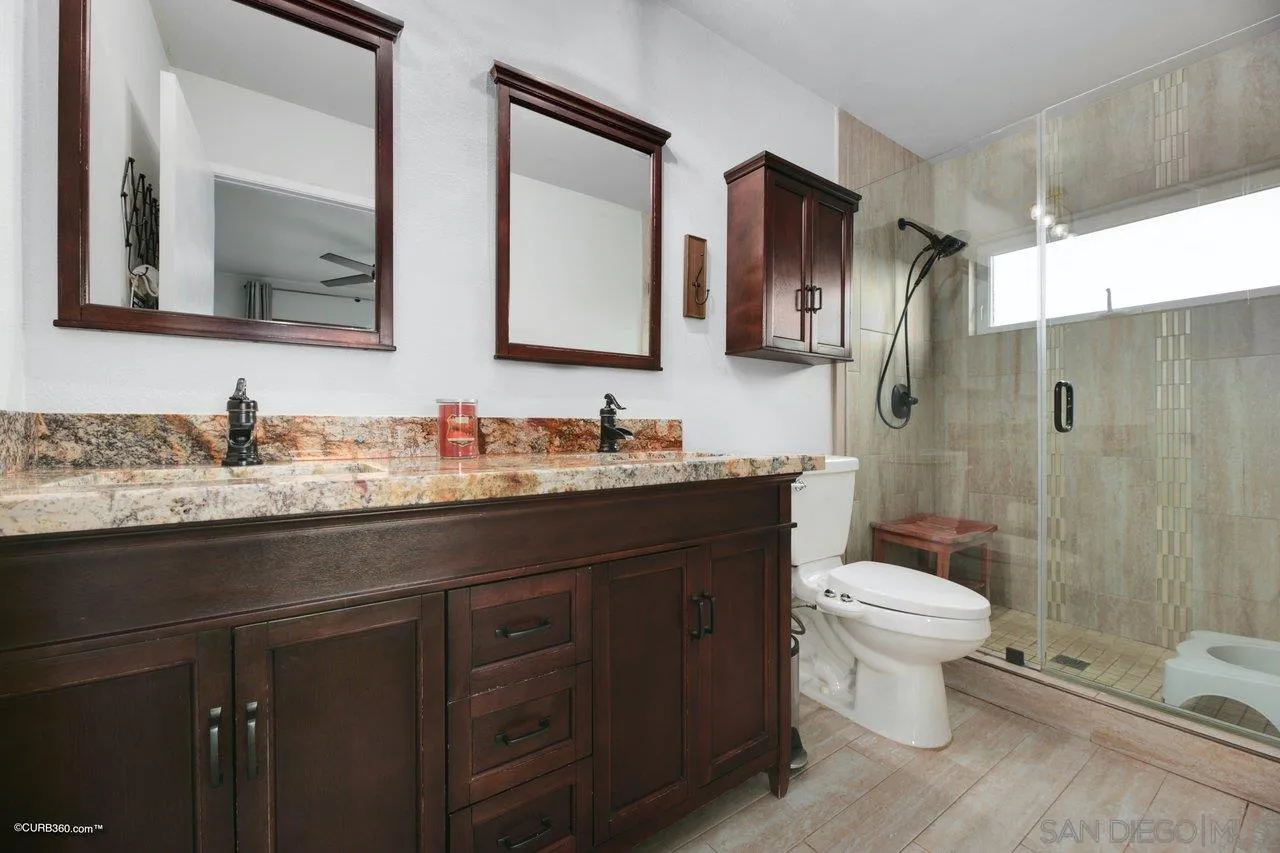 2925 Cordrey Drive Escondido, CA 92029 - Photo 16 of 75 a bathroom with a sink toilet a mirror and shower