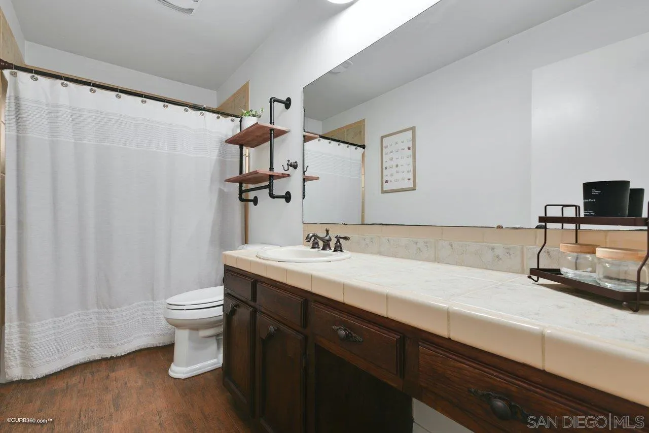 2925 Cordrey Drive Escondido, CA 92029 - Photo 34 of 75 a bathroom with a sink a toilet a mirror and shower