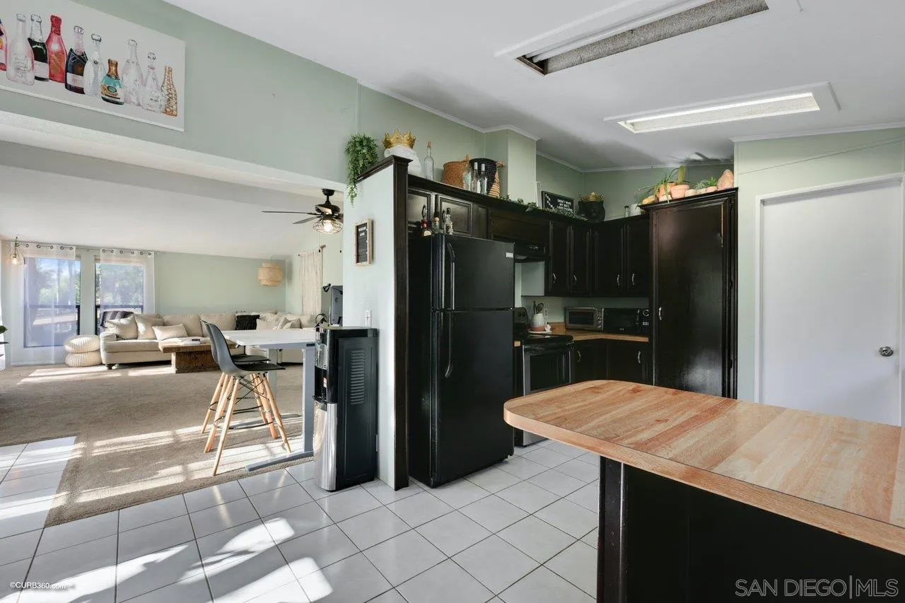 2925 Cordrey Drive Escondido, CA 92029 - Photo 59 of 75 a kitchen with stainless steel appliances kitchen island granite countertop a refrigerator and a sink