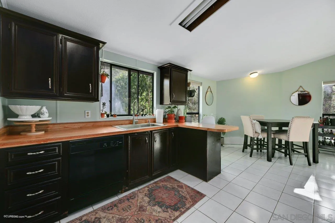 2925 Cordrey Drive Escondido, CA 92029 - Photo 61 of 75 a open kitchen with a sink and dishwasher with a dining table