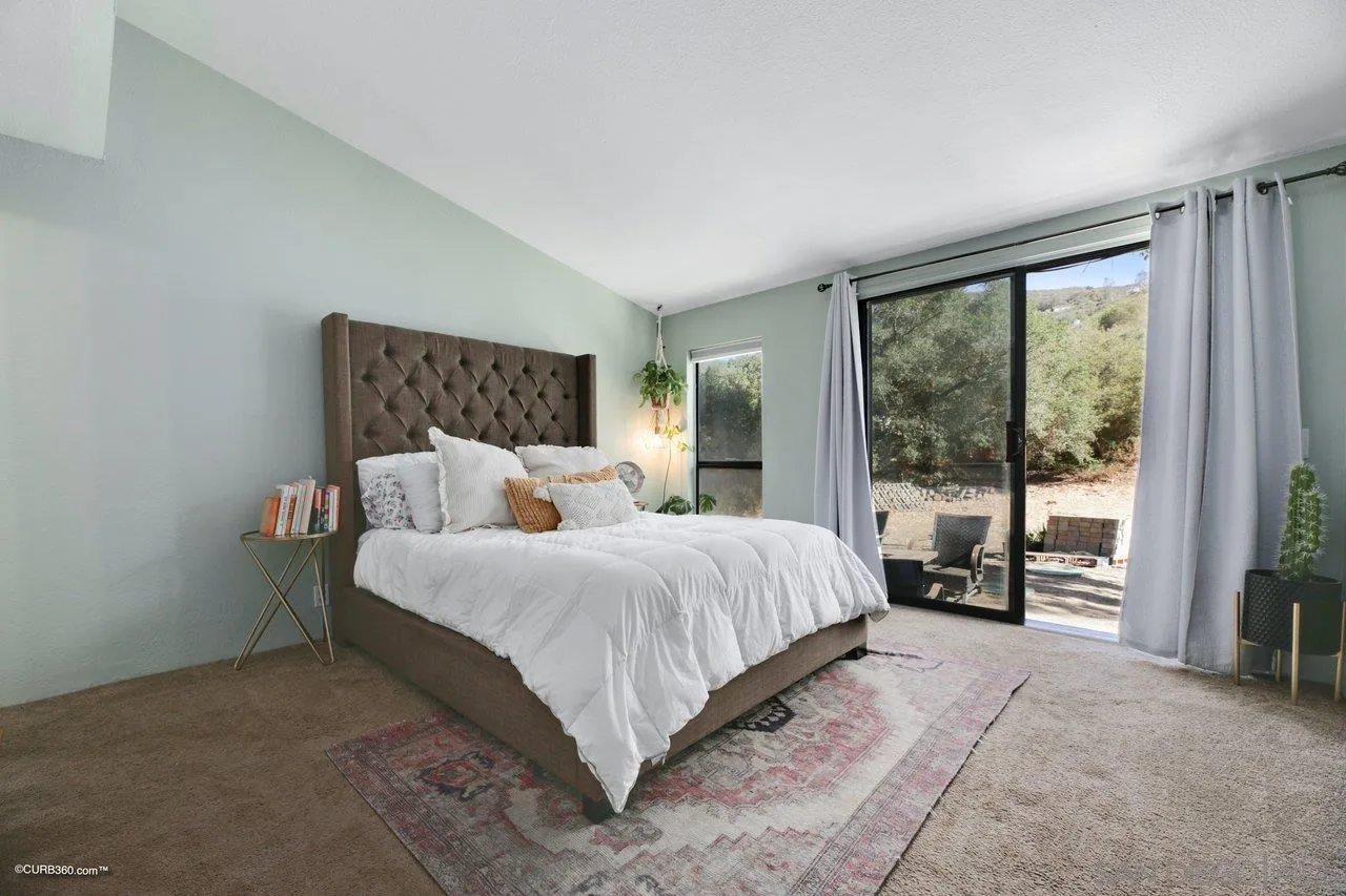 2925 Cordrey Drive Escondido, CA 92029 - Photo 63 of 75 a bedroom with a large bed and a large window