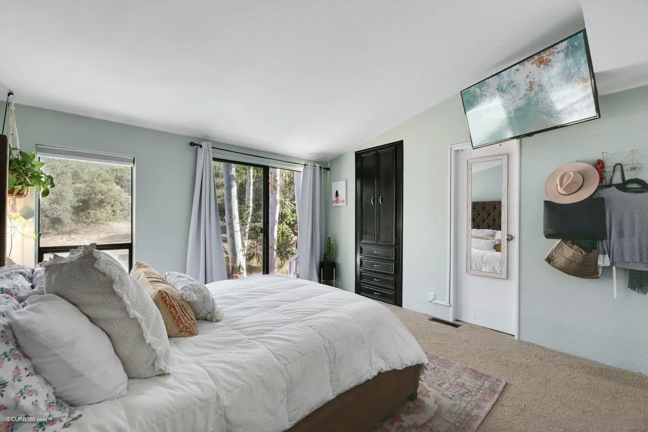 2925 Cordrey Drive Escondido, CA 92029 - Photo 65 of 75 a bedroom with a large bed and a window