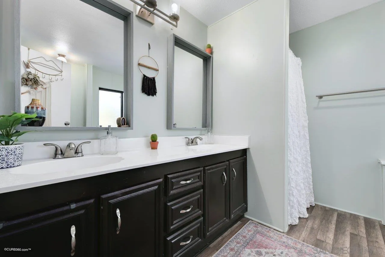 2925 Cordrey Drive Escondido, CA 92029 - Photo 66 of 75 a bathroom with a double vanity sink and a mirror