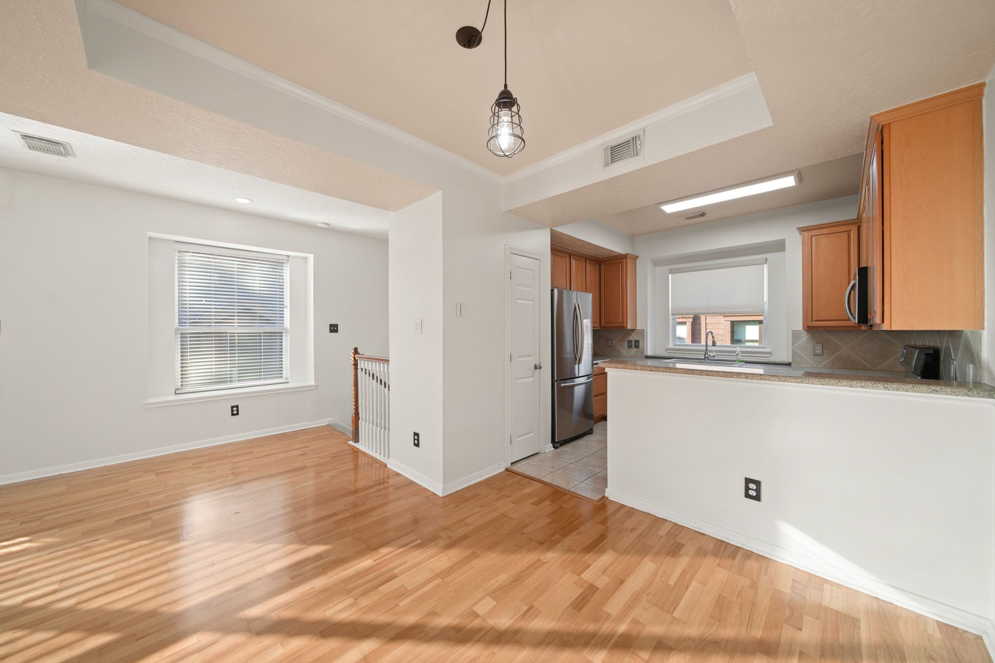 813 Davis Road League City, TX 77573 - Photo 11 of 22 a view of a kitchen with wooden floor and a window