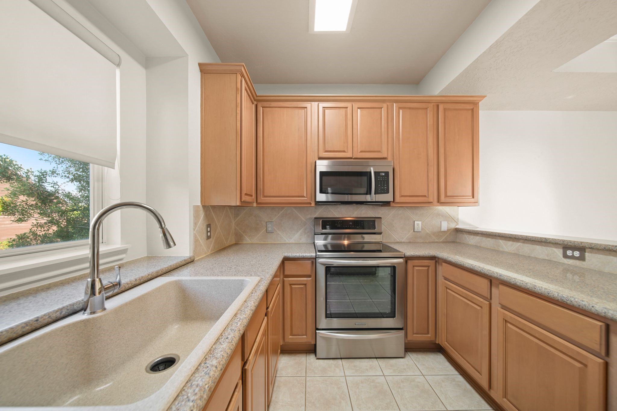 813 Davis Road League City, TX 77573 - Photo 12 of 22 a kitchen with stainless steel appliances granite countertop a sink stove and microwave