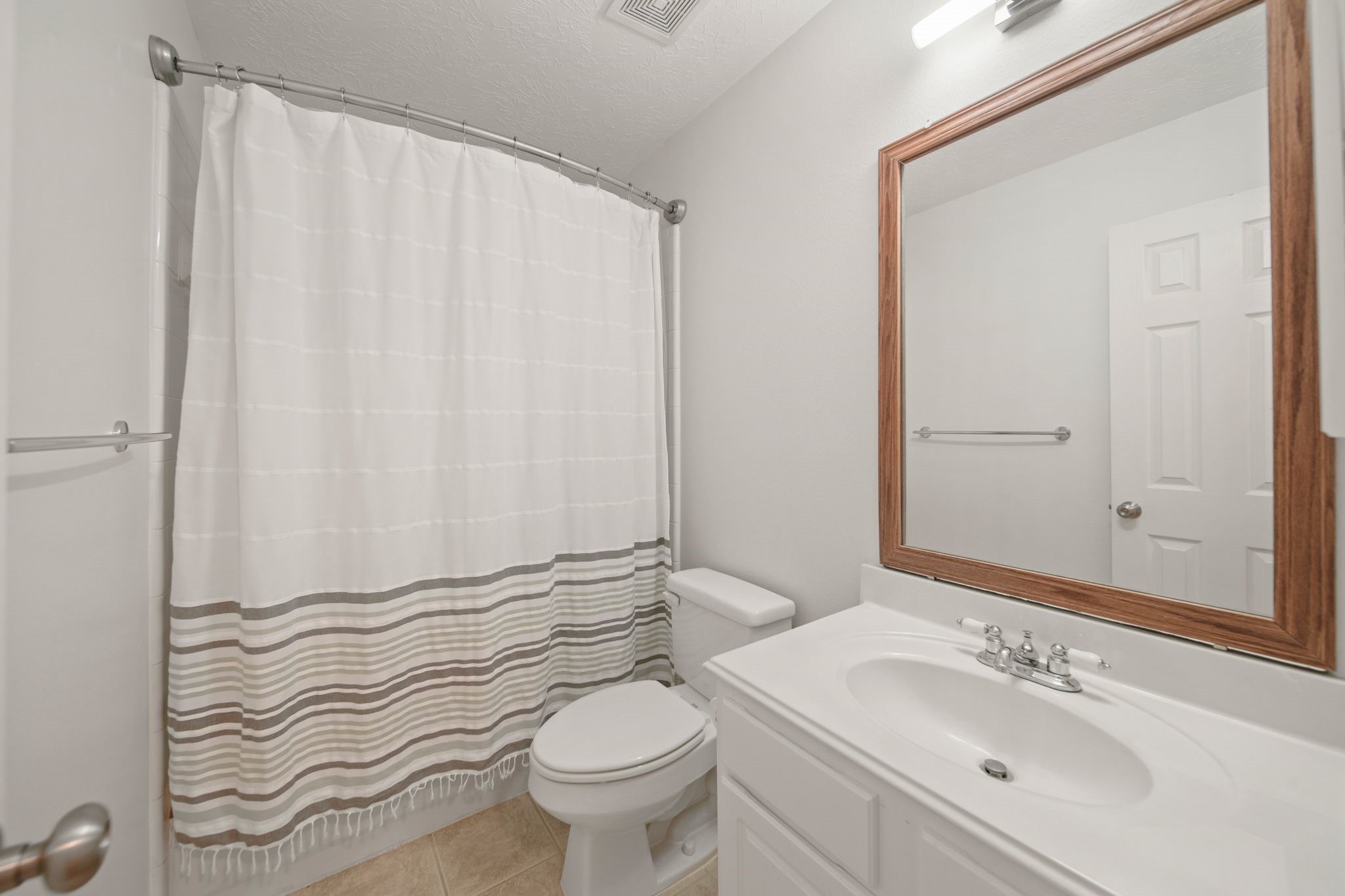 813 Davis Road League City, TX 77573 - Photo 18 of 22 a bathroom with a sink a toilet and shower curtain