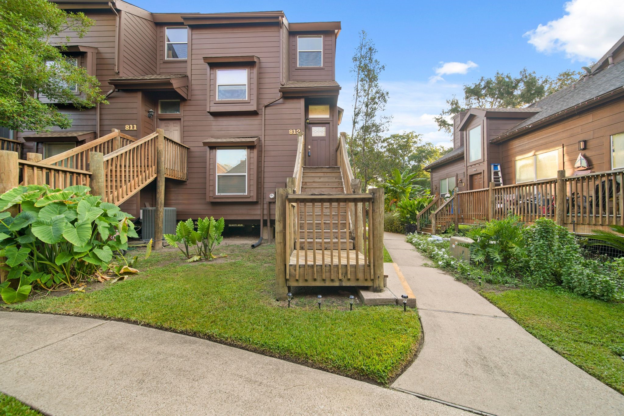 813 Davis Road League City, TX 77573 - Photo 22 of 22 a view of a brick house with a yard plants and large tree
