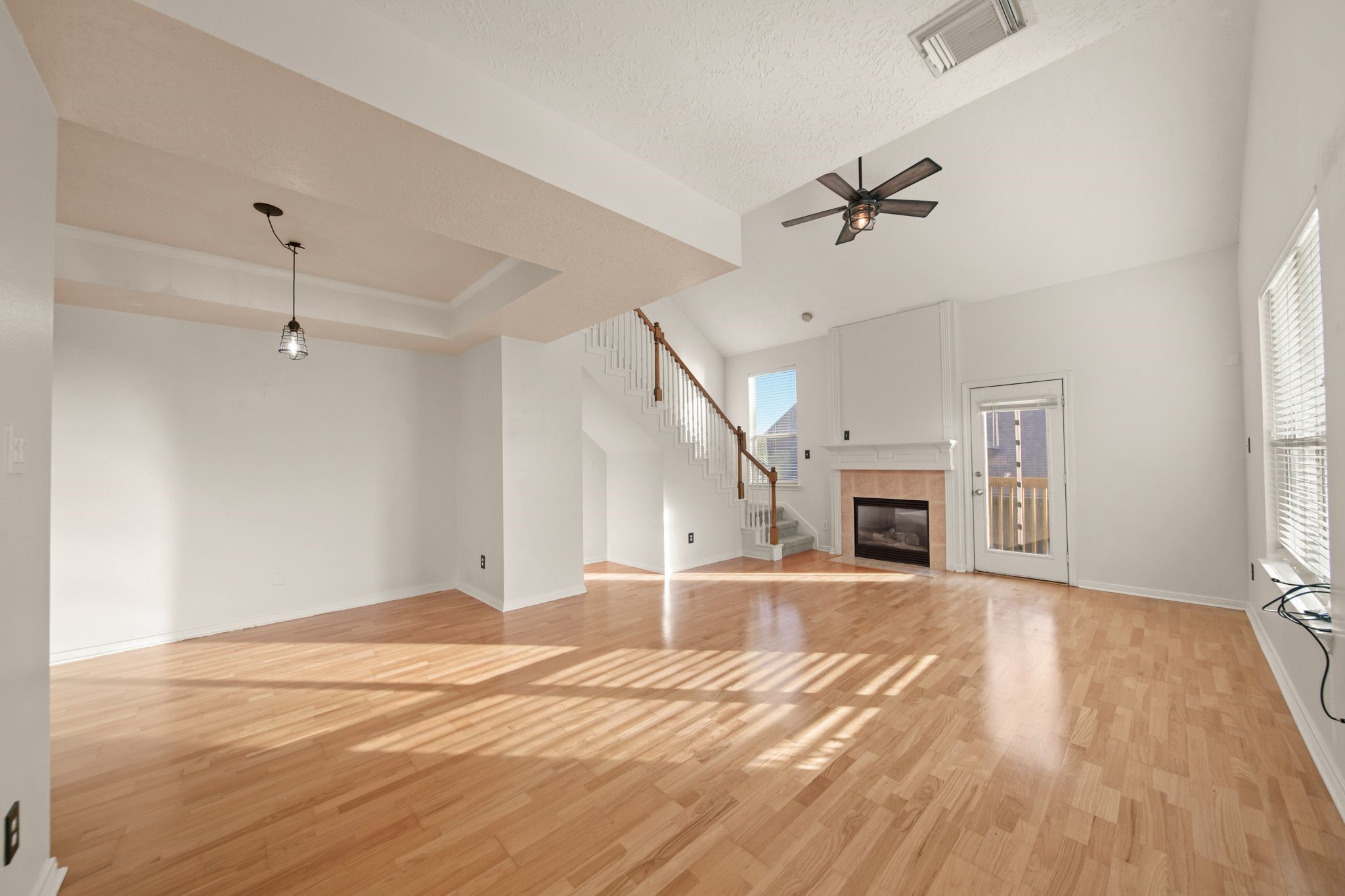 813 Davis Road League City, TX 77573 - Photo 9 of 22 an empty room with wooden floor fireplace and windows
