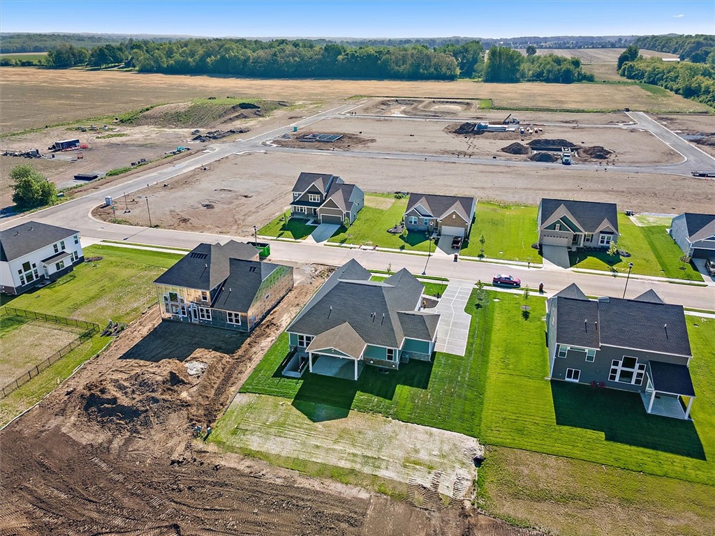407 South Landon Lane Springfield, OH 45502 - Photo 27 of 30 An aerial perspective showcases a vibrant new development with fresh lawns and modern homes against a backdrop of open fields.