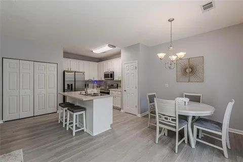 a kitchen with a refrigerator sink and cabinets