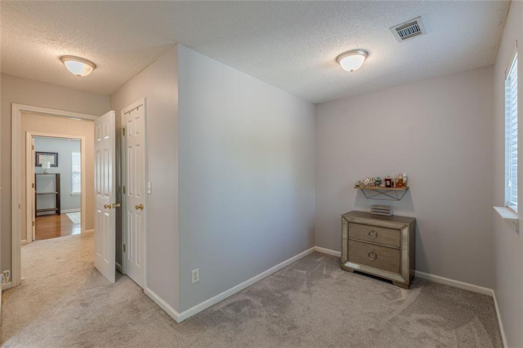 7640 Rutgers Circle Fairburn, GA 30213 - Photo 28 of 46 an empty room with a bench and mirror
