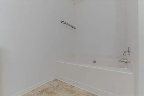 an empty room with closet and a bathroom