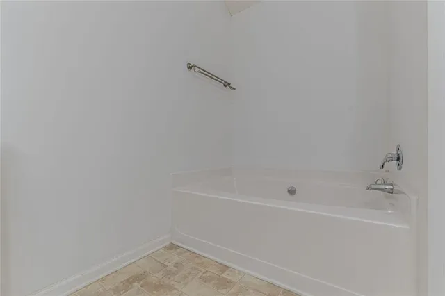 an empty room with closet and a bathroom