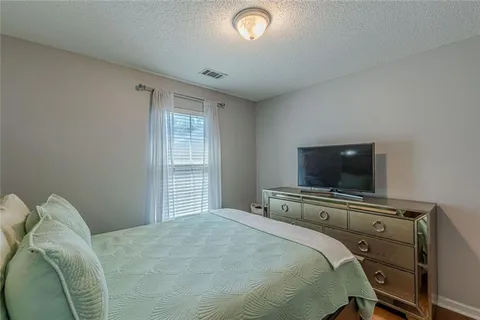 a bedroom with a large bed and a window