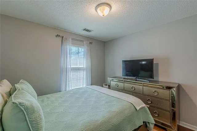 a bedroom with a large bed and a window