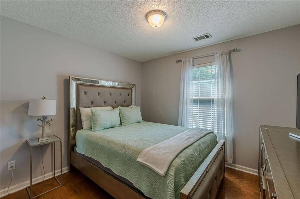 7640 Rutgers Circle Fairburn, GA 30213 - Photo 36 of 46 a bedroom with a large bed and a window