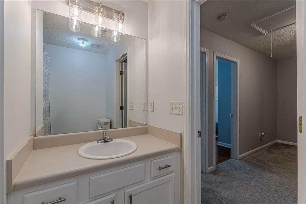 7640 Rutgers Circle Fairburn, GA 30213 - Photo 42 of 46 a bathroom with a sink and a mirror