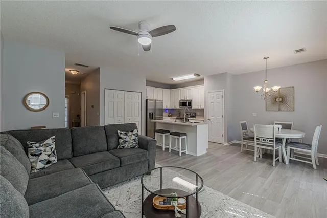 a kitchen with a stove a sink a dining table and chairs