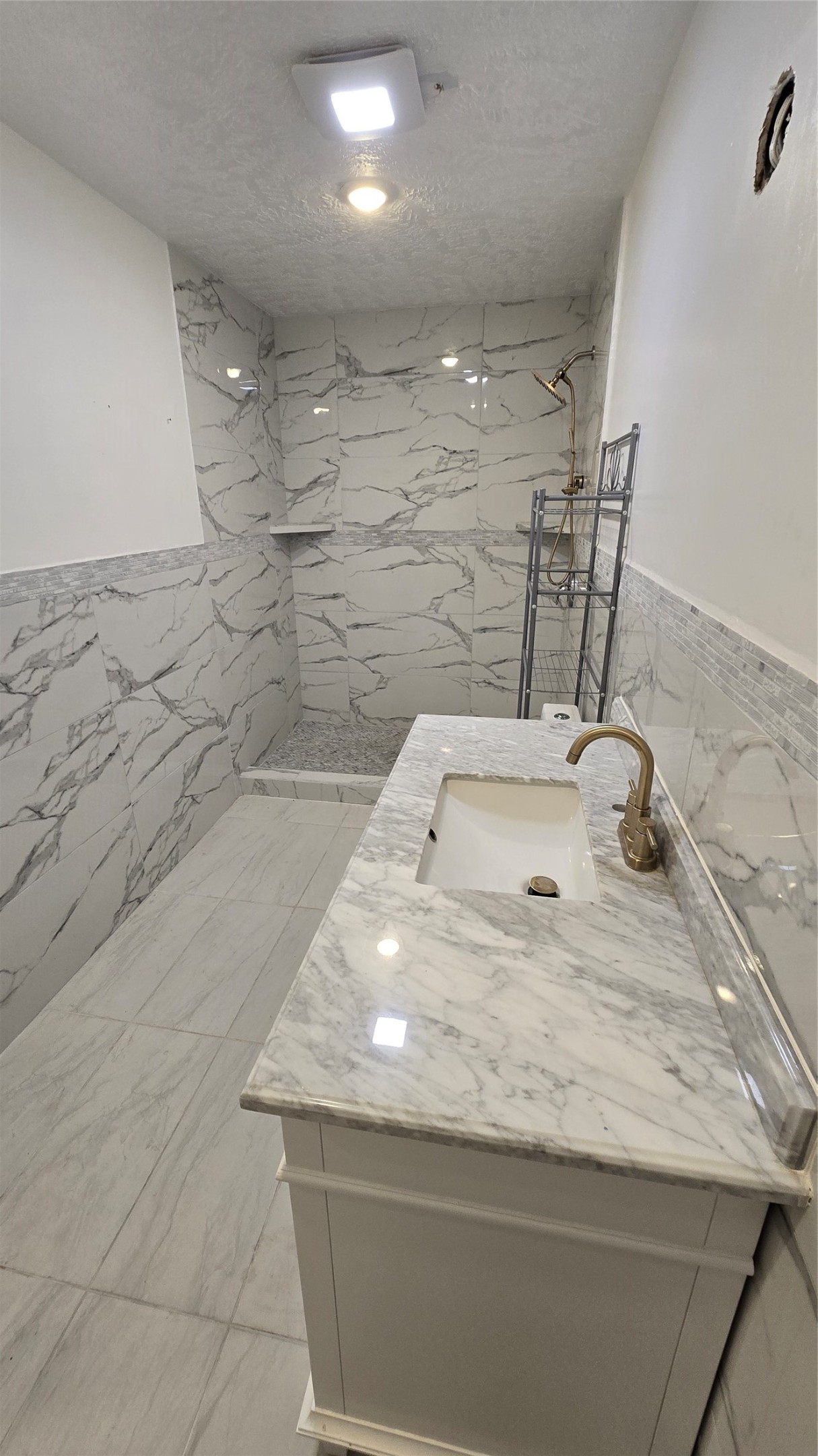 6076 Road 3550 Cleveland, TX 77327 - Photo 12 of 20 a bathroom with a granite countertop sink a toilet and shower