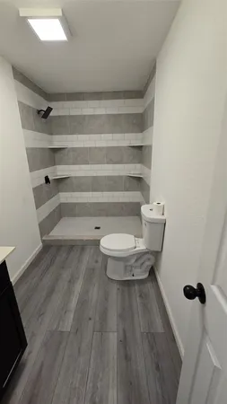 a kitchen with a sink cabinets and wooden floor
