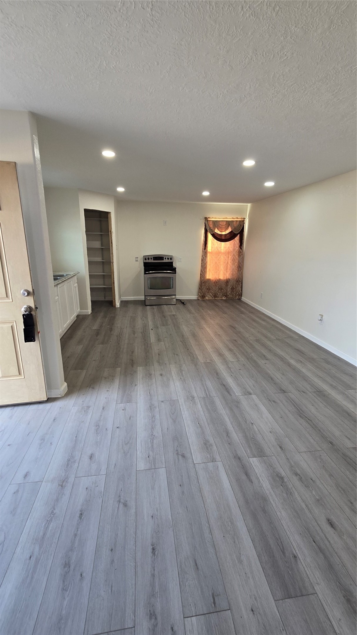 6076 Road 3550 Cleveland, TX 77327 - Photo 7 of 20 an empty room with wooden floor and windows