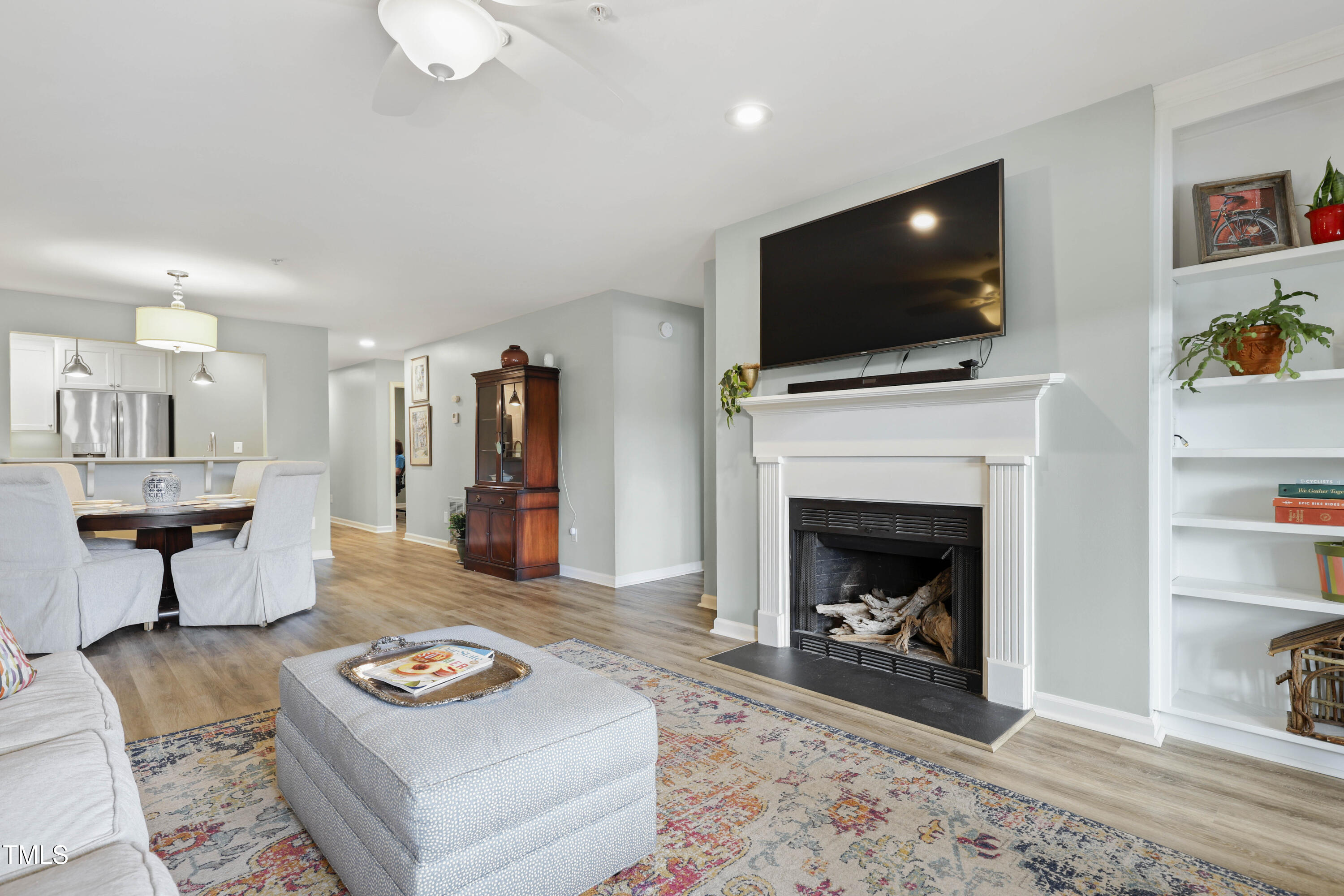720 Springfork Drive Cary, NC 27513 - Photo 13 of 34 a living room with furniture a flat screen tv and a fireplace
