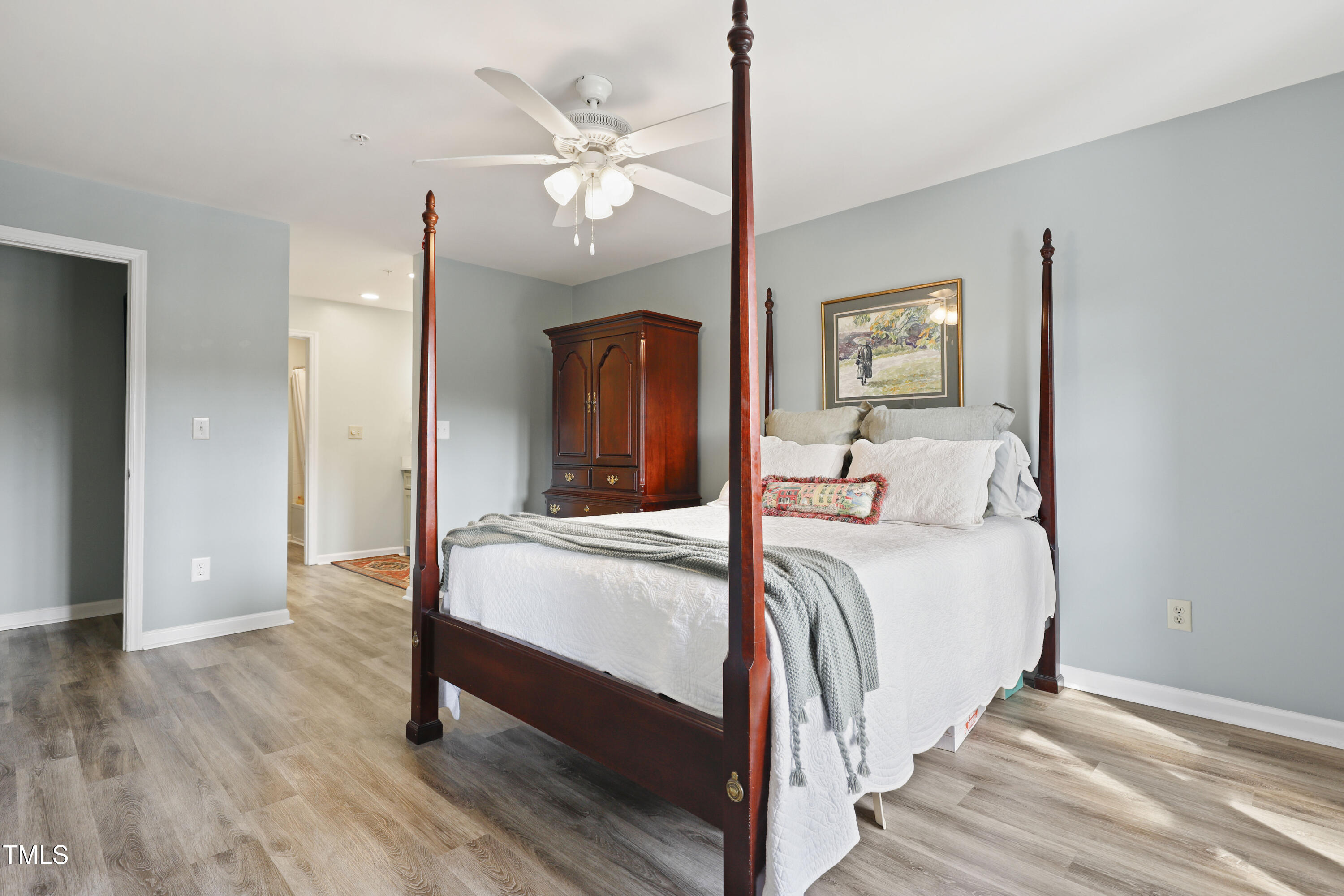 720 Springfork Drive Cary, NC 27513 - Photo 15 of 34 a bed room with a bed and a chandelier