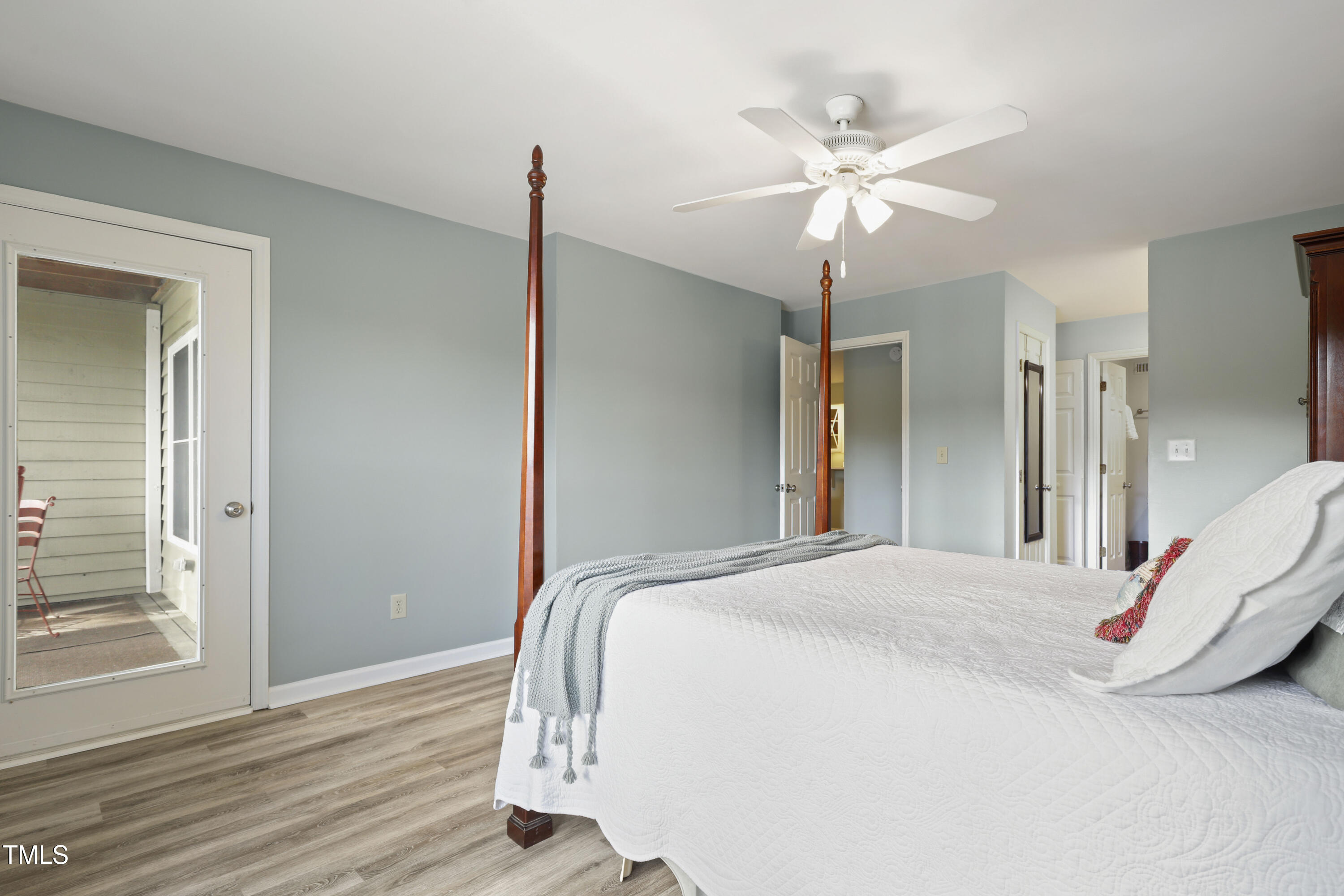 720 Springfork Drive Cary, NC 27513 - Photo 16 of 34 a bedroom with a bed and a chandelier