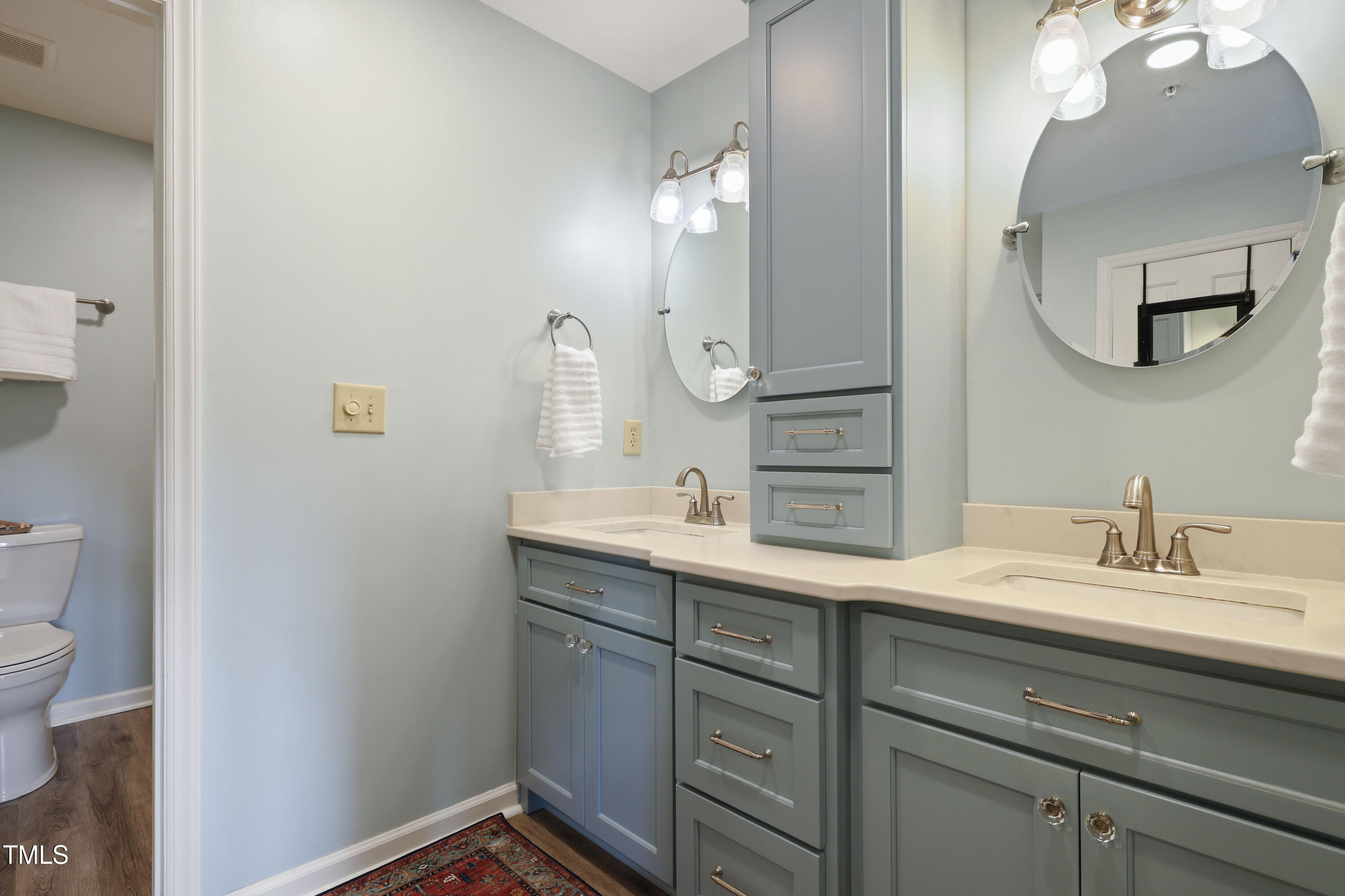 720 Springfork Drive Cary, NC 27513 - Photo 17 of 34 a bathroom with a sink and a mirror