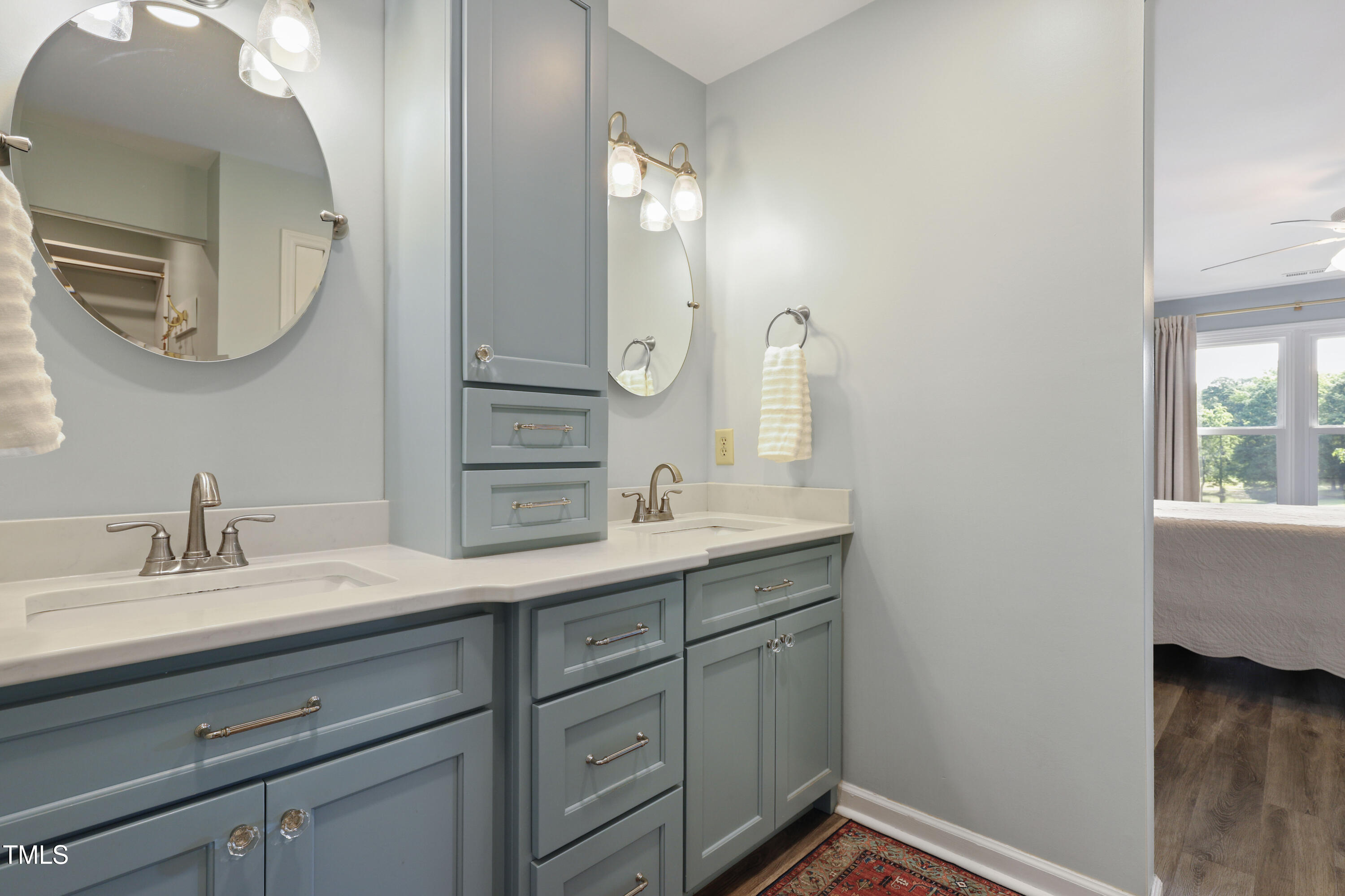 720 Springfork Drive Cary, NC 27513 - Photo 18 of 34 a en suite bathroom with a double vanity sink and a mirror