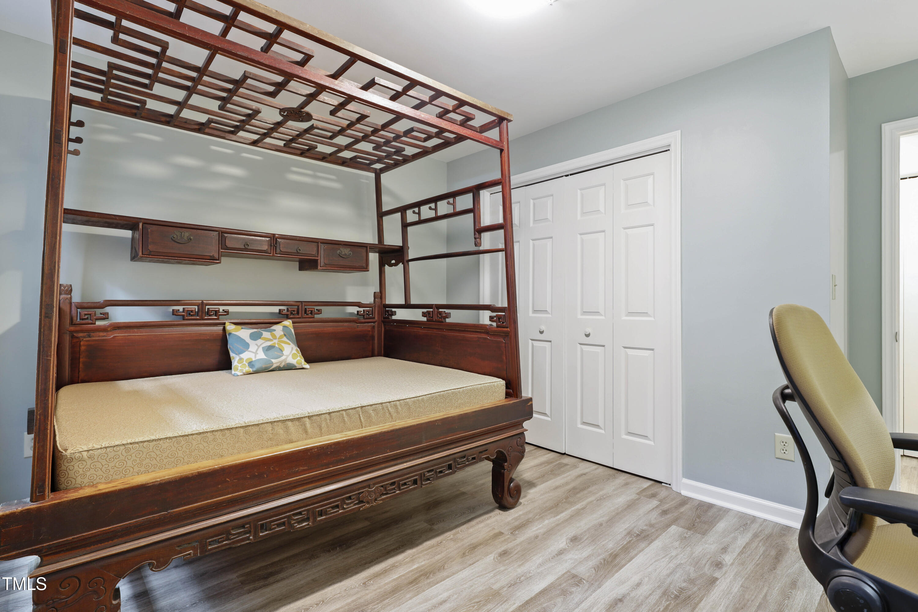 720 Springfork Drive Cary, NC 27513 - Photo 22 of 34 a bedroom with a bed and a chair