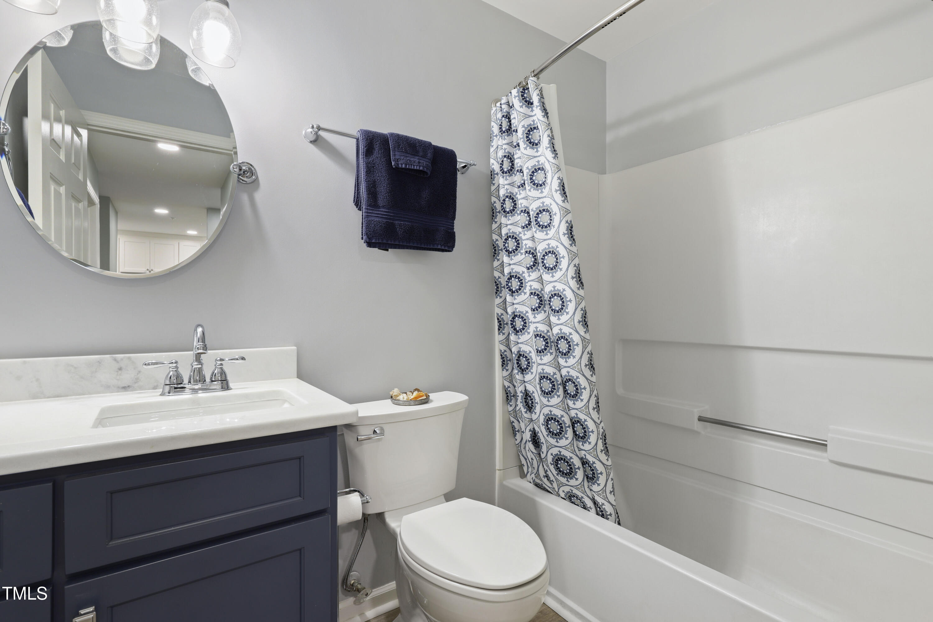 720 Springfork Drive Cary, NC 27513 - Photo 23 of 34 a bathroom with a sink a toilet and a mirror