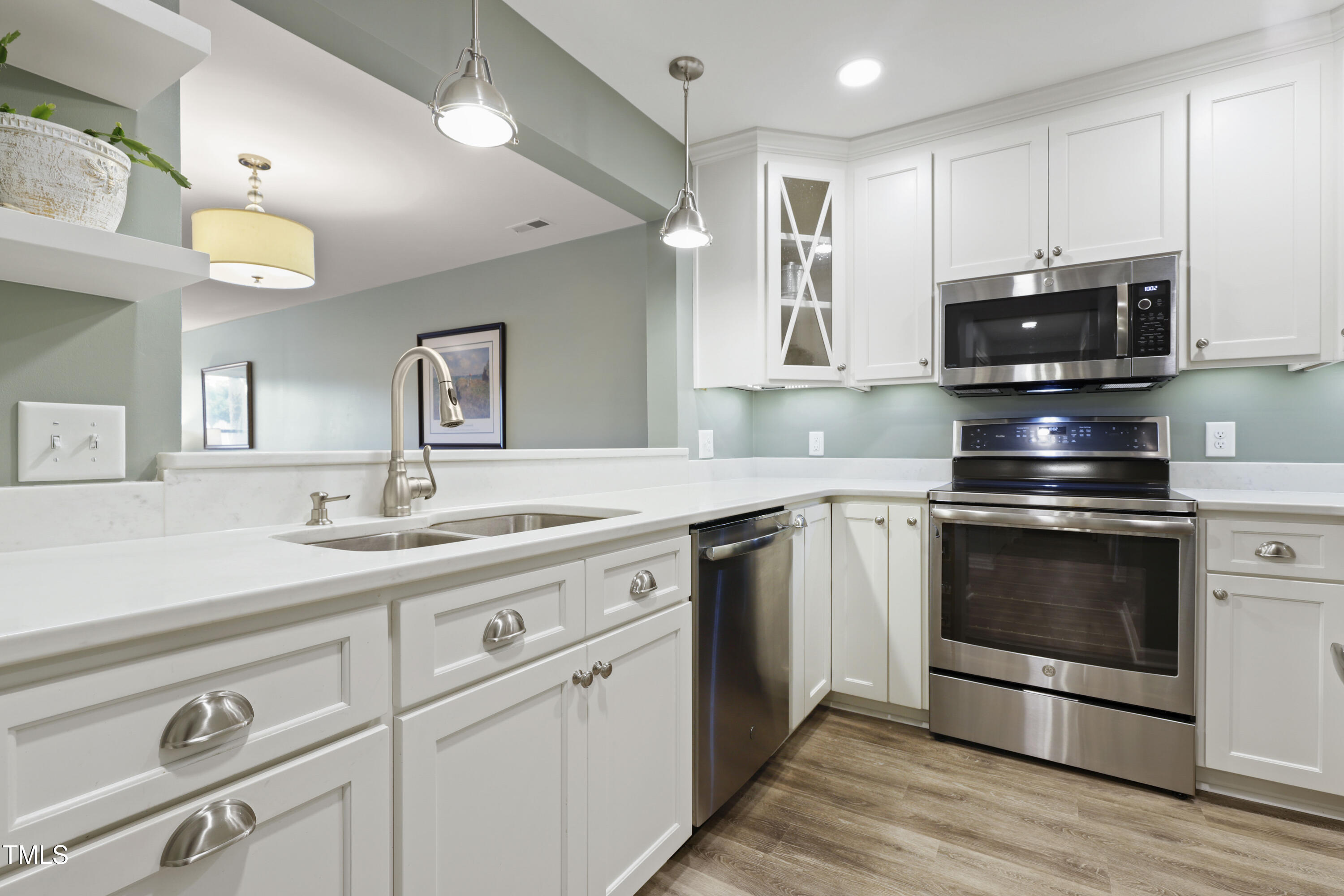 720 Springfork Drive Cary, NC 27513 - Photo 4 of 34 a kitchen with stainless steel appliances granite countertop a stove a sink and a microwave