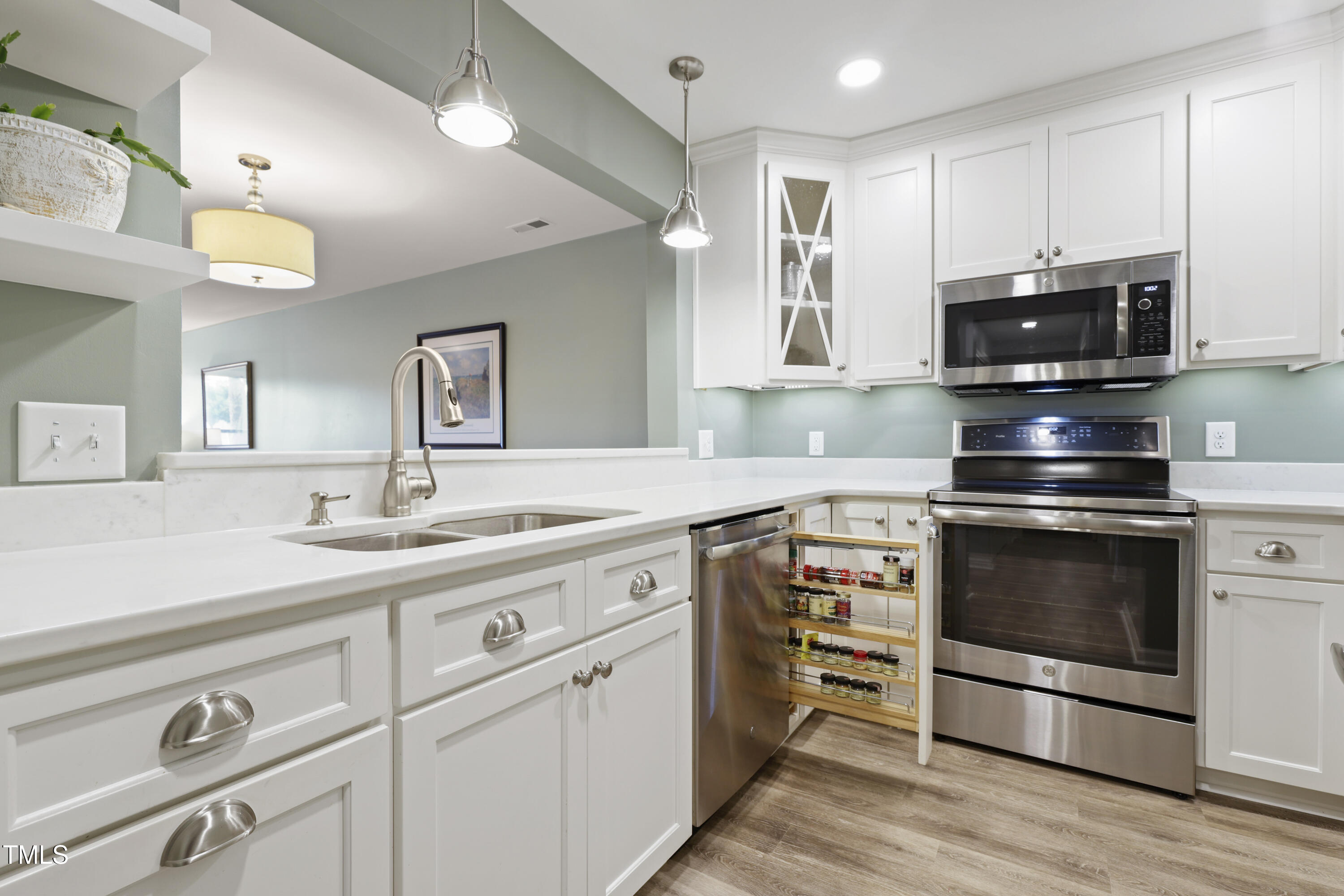 720 Springfork Drive Cary, NC 27513 - Photo 5 of 34 a kitchen with stainless steel appliances granite countertop a stove and a sink