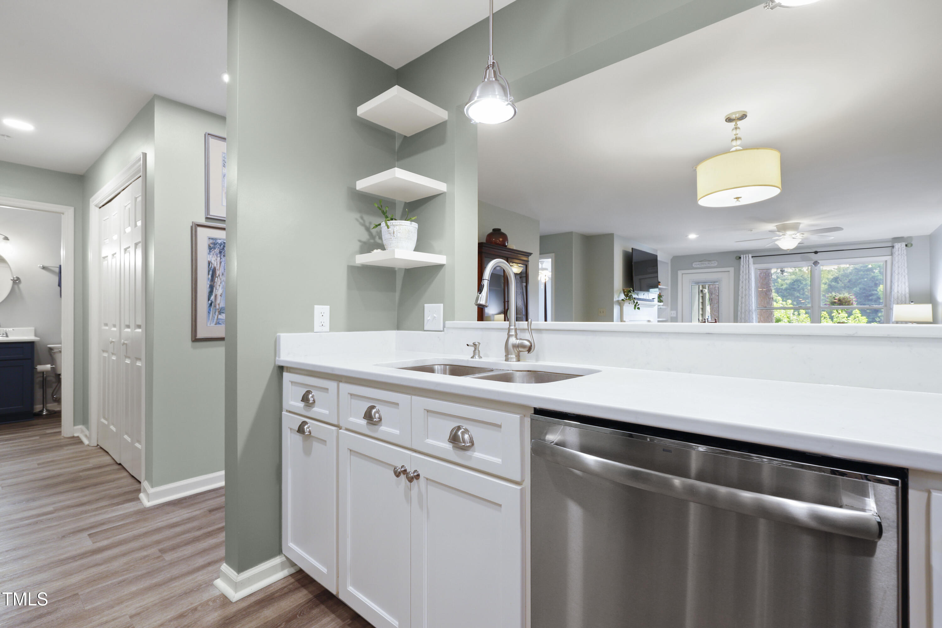 720 Springfork Drive Cary, NC 27513 - Photo 7 of 34 a kitchen with a sink and a refrigerator
