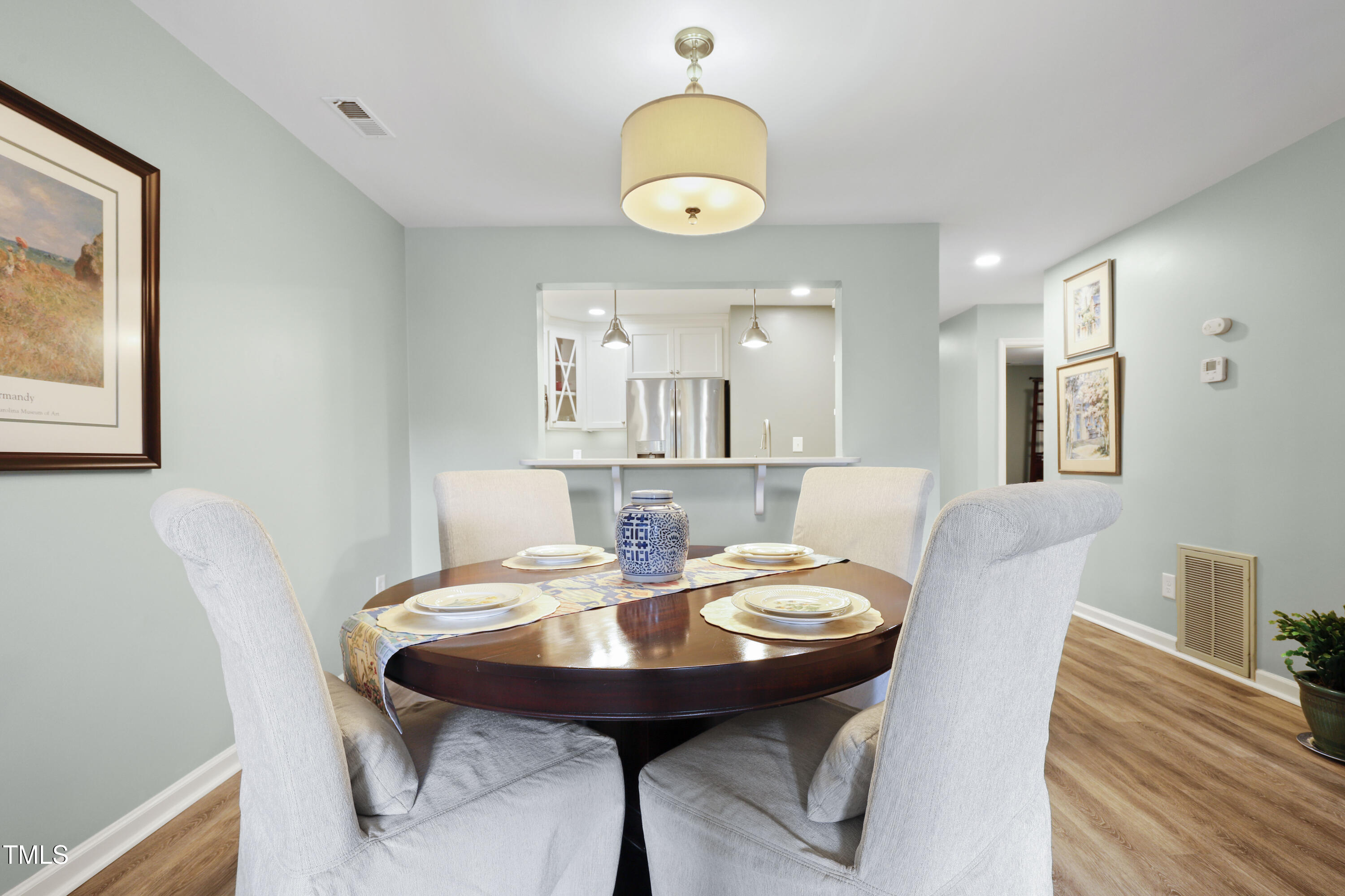720 Springfork Drive Cary, NC 27513 - Photo 9 of 34 a view of a dining room with furniture and wooden floor