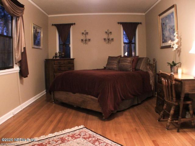 1318 Nicholson Road Jacksonville, FL 32207 - Photo 12 of 19 a bedroom with a bed and wooden floor