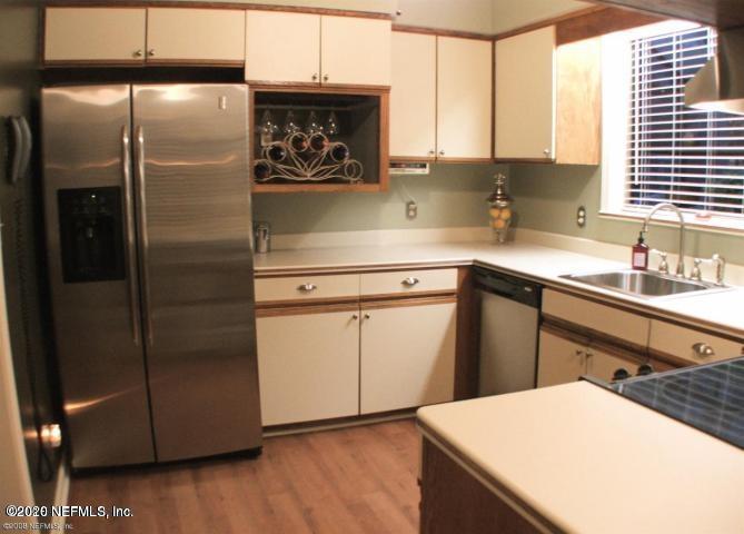1318 Nicholson Road Jacksonville, FL 32207 - Photo 13 of 19 a kitchen with a sink a refrigerator and cabinets