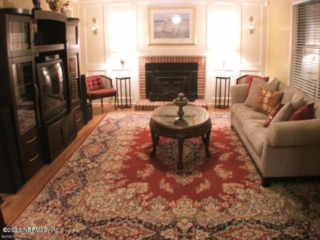 1318 Nicholson Road Jacksonville, FL 32207 - Photo 10 of 19 a living room with furniture a fireplace and a table